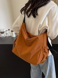 Large capacity orange nylon crossbody messenger bag with adjustable wide shoulder strap