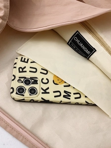 Light pink nylon tote bag interior showing zipper pocket and spacious lining
