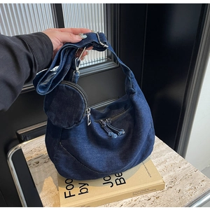 Dettaglio della borsa hobo in denim blu scuro con tracolla regolabile e portamonete