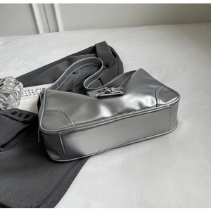 Macro shot of silver metallic shoulder bag with white contrast stitching and PU texture