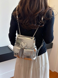 Silver metallic mini backpack for women with heart detail and stylish chain straps