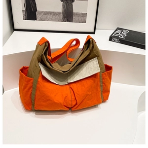 Detail view of khaki and orange canvas messenger bag with large capacity and multi-pockets