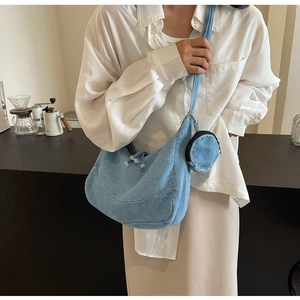 Chic light blue denim crescent shoulder bag with matching mini round coin purse