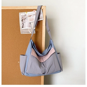 Detail view of large canvas messenger bag with contrast piping and adjustable strap buckle