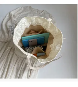 Interior view of large textured tote bag showing multi-pocket storage and spacious capacity