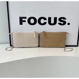 Close-up of woven chain bags with silver bead trim in beige and brown colors