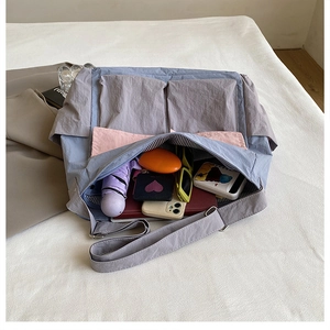 Detailed view of spacious pink tote bag with multiple pockets and interior organization