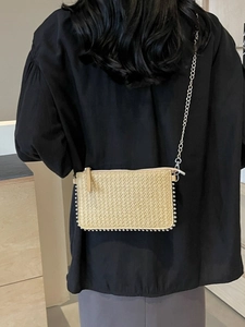 Women's straw woven crossbody phone bag with silver beaded trim and metal chain strap