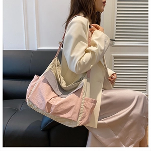 Detail of multi-pocket patchwork canvas bag featuring durable nylon texture and adjustable straps