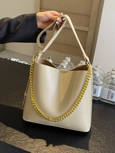 Chic beige faux leather tote bag with gold chain and adjustable shoulder strap