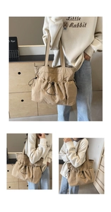 Detail of khaki pleated tote bag featuring functional drawstring utility pockets for storage