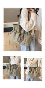Detail view of khaki green pleated tote bag with drawstring pocket and spacious design