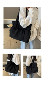 Close-up of black pleated tote bag with drawstring pockets and nylon texture details