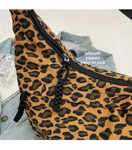 Close-up of leopard print canvas bag with smooth black metal zipper and cord pull