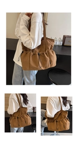 Detail view of large caramel brown tote bag with side drawstring pockets and wide strap