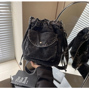 Detail der vintage gewaschenen schwarzen Denim-Beuteltasche mit Kordelzug und Vordertasche