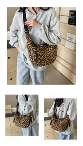 Detail view of leopard print canvas crescent bag with adjustable wide black strap