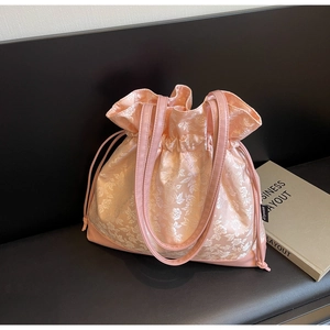 Detail of pink floral brocade satin drawstring bag with elegant leather handles