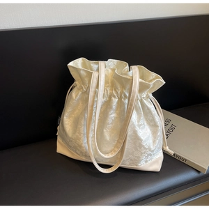 Detail shot of cream jacquard tote bag featuring floral texture and drawstring closure