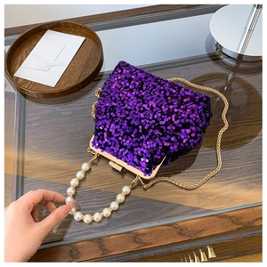 Detailansicht der lila Pailletten-Abendtasche mit Goldkette und Perlen-Handgriff