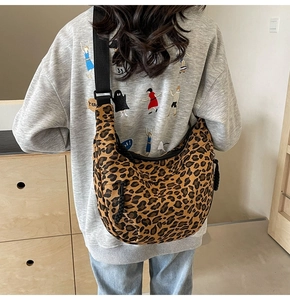 Detail shot of leopard print canvas hobo bag showing spacious design and wide strap