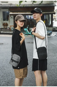 Detail view of stylish crossbody bags with multiple compartments on urban models