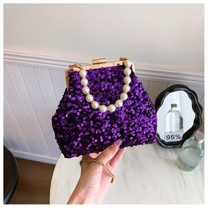 Detail der lila Pailletten-Muscheltasche mit Perlengriff und goldener Kette