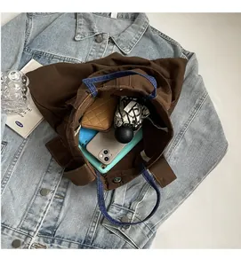 Macro top view of brown canvas tote interior showing spacious storage for daily essentials
