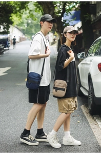 Outdoor street view of models wearing large capacity waterproof nylon crossbody bags