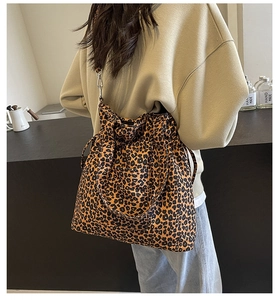 Detailed view of leopard print canvas tote bag featuring drawstring closure and wide strap