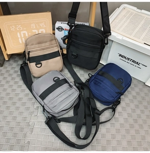 Close-up of durable nylon messenger bags in khaki, black, grey and navy blue colors