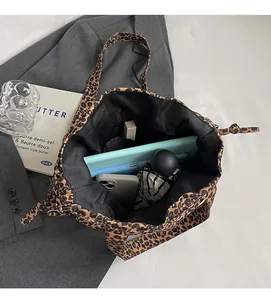 Interior view of large leopard print canvas tote bag showing high storage capacity for daily items