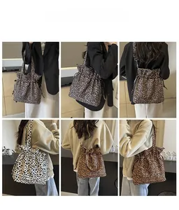 Detail view of leopard print canvas tote bag with drawstring closure and versatile straps