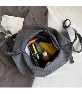 Detailansicht der grauen Plissee-Tasche mit geräumigem Innenraum und Reißverschluss