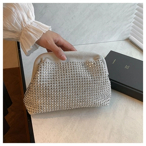 Macro view of grey cloud clutch bag featuring dense shimmering silver rhinestones