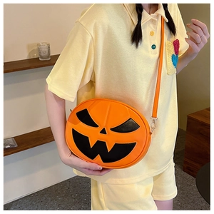 Crossbody pumpkin bag with festive face detail and orange faux leather strap