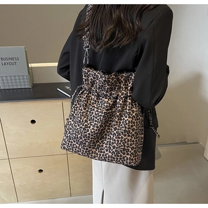 Detailed back view of a leopard print canvas drawstring bucket bag with wide strap