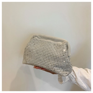 Macro detail of silver rhinestones and magnetic frame on this luxury shell evening bag