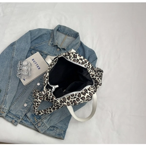 Top view of leopard print canvas tote bag with inner lining and zipper closure detail