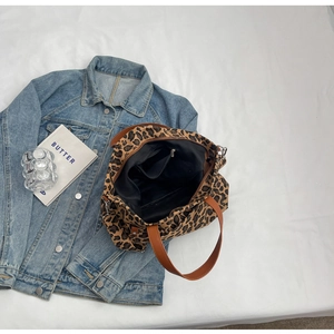 Detail view of the spacious leopard print canvas tote interior with zipper pocket and lining