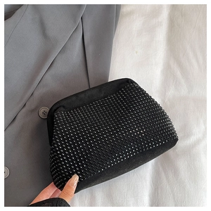 Close-up of black rhinestone evening clutch bag showing detailed crystal texture