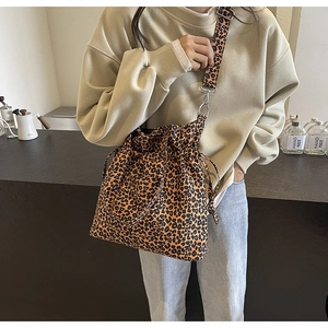 Close-up of leopard print canvas bucket bag with drawstring closure and wide strap