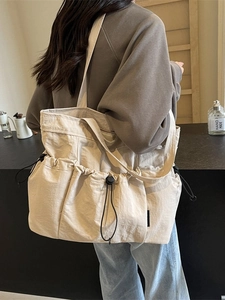 Large beige pleated tote bag with multi-pocket drawstring design for casual commuting