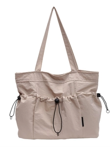 Minimalist beige pleated nylon tote bag with drawstring pockets for daily commute