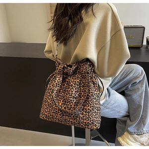 Detail view of large leopard print canvas tote bag with adjustable shoulder strap