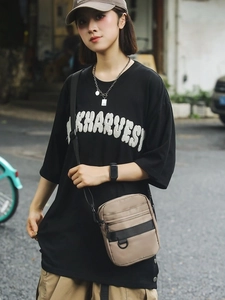 Men's light brown nylon crossbody bag with adjustable black strap for casual commuting