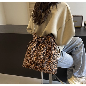 Detail view of the leopard print canvas tote bag with functional drawstring closure