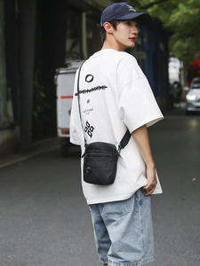 Minimalist black crossbody bag for men with adjustable strap and multiple zipper compartments