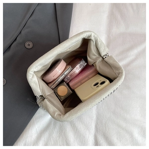 Detailed view of rhinestone clutch interior showing spacious capacity for phone and cosmetics