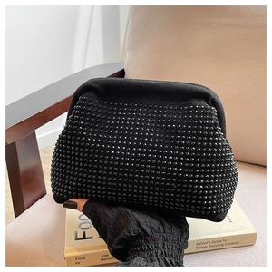 Detail shot of the black shell-shaped evening bag featuring high-density studded rhinestones